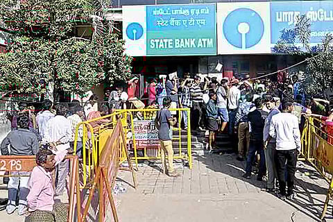 File picture of a long queue in front of an ATM counter in the city