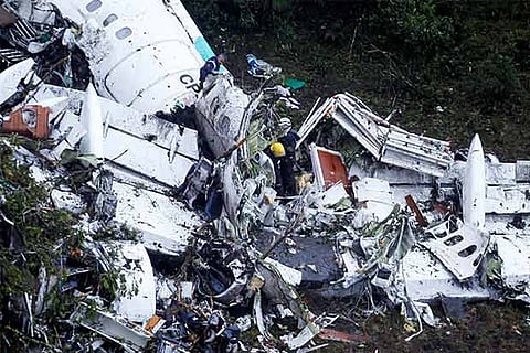 Rescue crew work at the wreckage from a plane that crashed into Colombian jungle