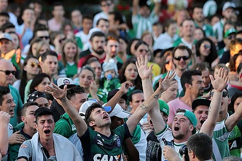 Fans of Chapecoense soccer team gather in the streets to pay tribute to their players in Chapeco