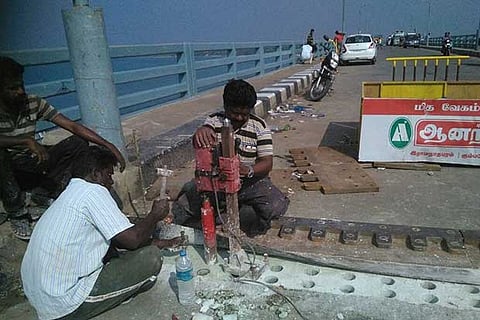 Men fixing the damaged screws on the Pamban road bridge in Rameswaram