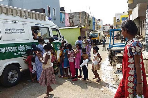 Women and children thronging a medical van in the city