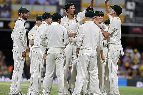 Australia's Mitchell Starc, center, celebrates with his teammates