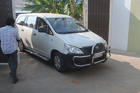 Income Tax officials coming out after raiding Ramachandran?s office in Pudukkottai on Saturday