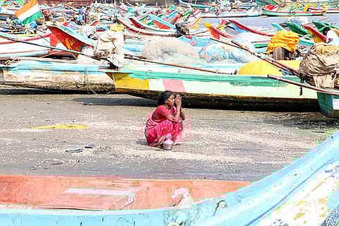 A woman pray for her relatives who died in tsunami in Chennai