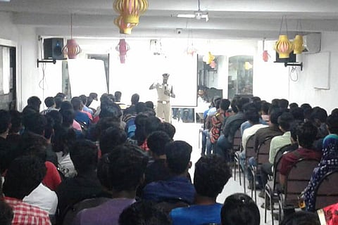 A police officer briefs college students on patrolling the streets during New Year celebrations