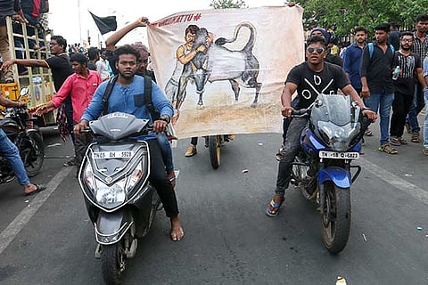 Youth on two-wheelers holding a poster during the protests held in support of jallikattu in the city