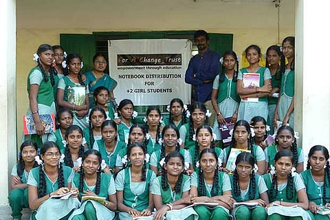 Students pose with the notebooks they received as gifts