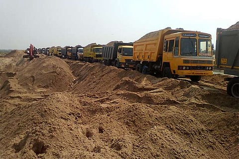 The lorries being loaded with sand mined from the Cauvery bed near Lalgudi region