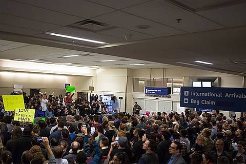 Protesters gather to denounce President Donald Trump's executive order