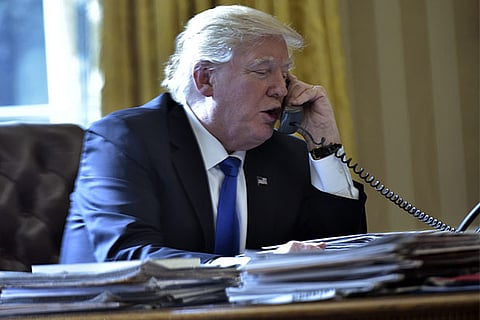 US President Donald Trump speaks on the phone with Russia's President Vladimir Putin