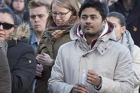 People attend a vigil for victims of a Sunday shooting at a mosque in Quebec City
