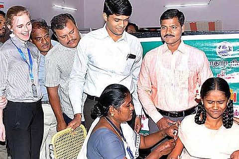 A schoolgirl gets vaccinated for measles and rubella in Madurai