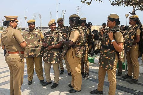 Police personnel take position on the sands of the Marina Beach in Chennai