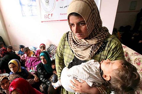 A woman standing with her child