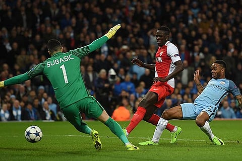 Manchester City midfielder Raheem Sterling (R) scores the opening goal