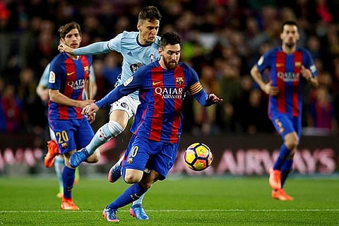 Barcelona?s Lionel Messi ( second right) duels for the ball against Celta Vigo?s Nemanja Radoja
