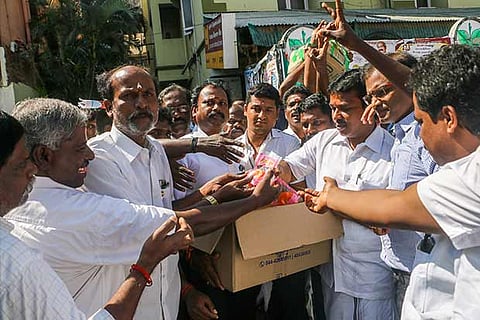 AIADMK cadre distributing sweets near Royapettah