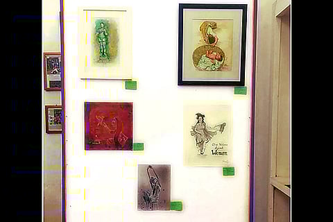 A makeshift wall featuring works of artists, young and old