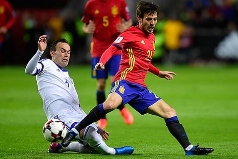 Spain?s David Silva (right) vies for the ball with Israel?s Bibras Natcho