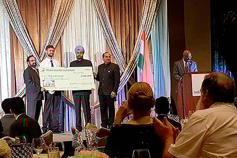 India?s Ambassador to the US Navtej Sarna hands over to Ian Grillot a cheque of $100,000