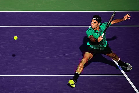 Roger Federer returns to Roberto Bautista Agut during their Miami Open match