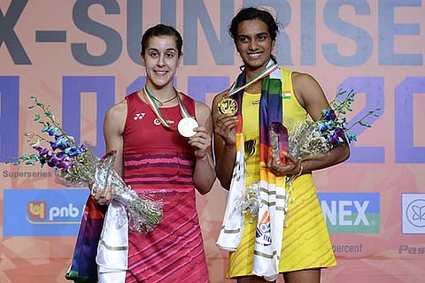 PV Sindhu (right) shows her gold medal after beating Carolina Marin in the India Open final