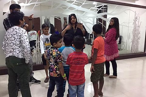 Children engaged in a group activity in a finishing school