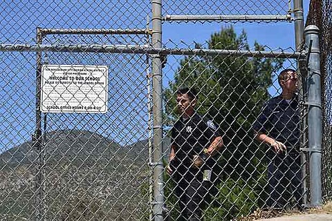 San Bernardino police officers man an entrance to the North Park Elementary School