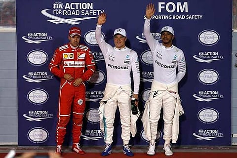 (L to R) Sebastian Vettel, Valtteri Bottas and Lewis Hamilton celebrate after the qualifying