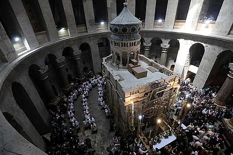 Christian worshippers surround the Edicule as they take part in a Sunday Easter mass