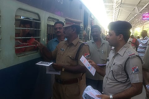 File photo of RPF personnel distributing awareness pamphlets to passengers
