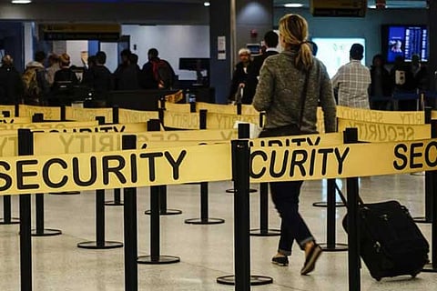 File photo of passengers making their way through a security checkpoint at JFK International airport