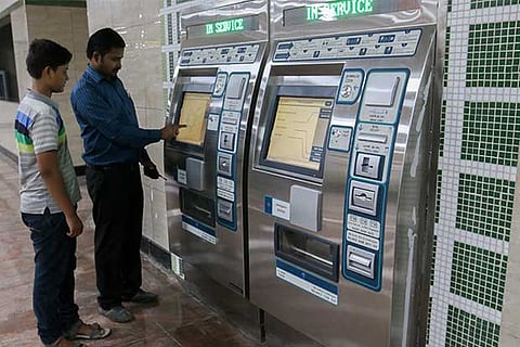 The ticket vending machine is being operated in one of the stations