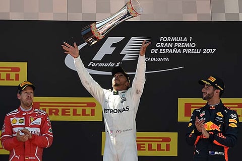 Lewis Hamilton (centre) celebrates his win with Sebastian Vettel (left) and Daniel Ricciardo