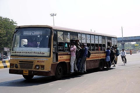 Passengers take a dangerous footboard ride in an MTC bus