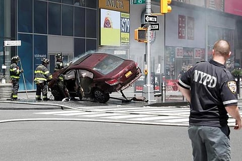 A vehicle that struck pedestrians in Times Square and later crashed is seen on the sidewalk