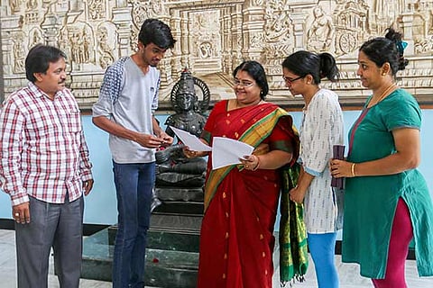 Students and principal of a school in Chennai looking at the CBSE results that were declared