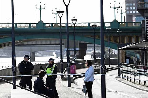 Police officers stand at a cordon near Blackfriars Bridge on the South Bank after the terror attacks