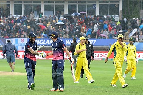 Ben Stokes congratulates Jos Buttler as players leave the field due to rain