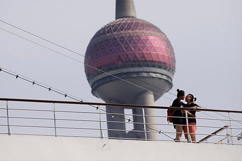 A Chinese gay couple, Xian Xian (L) and Tian Tian, hugs on a cruise ship