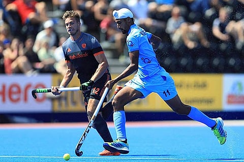 India's Mandeep Singh, right, and the Netherlands' Sander de Wijn battle for the ball