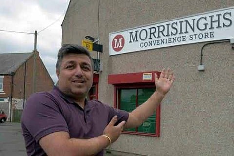 Jel Singh Nagra in front of his stores