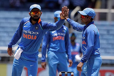Virat Kohli congratulates Kuldeep Yadav tor taking the catch to dismiss WI's Ashley Nurse