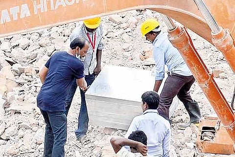 Workers retrieve the second safe vault from the fire-hit Chennai Silks building in T Nagar