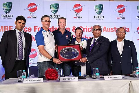 Glenn McGrath and Ryan Harris (centre) with Rahul Mammen, Arun Mammen and KM Mammen of MRF