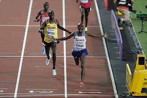 Mo Farah (right) wins the 10,000m race at the World Athletics Championships
