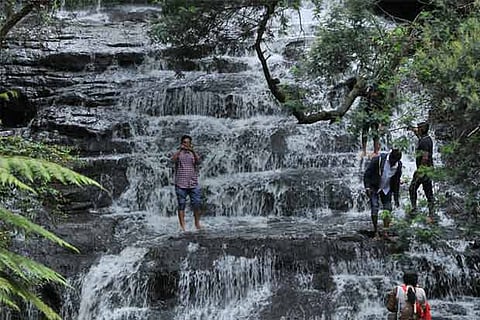 Visitors taking selfies at a falls in Vattakanal, a popular tourist destination in Kodaikanal
