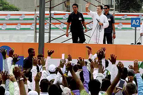 Congress VP Rahul Gandhi waves to the crowd during a "direct dialogue" with party workers