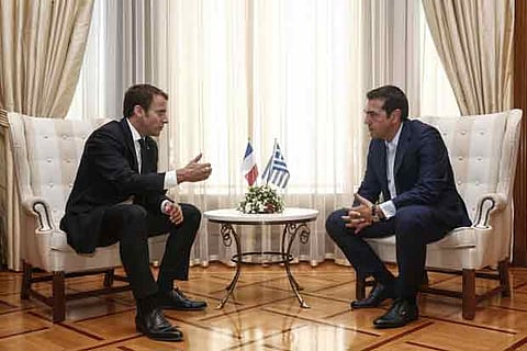Greek Prime Minister Alexis Tsipras (R) meets with French President Emmanuel Macron
