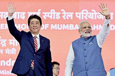 Prime Minister Narendra Modi and the Prime Minister of Japan, Shinzo Abe waves at the crowd
